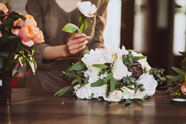 women holding rose and setting it on table in remembrance of someone