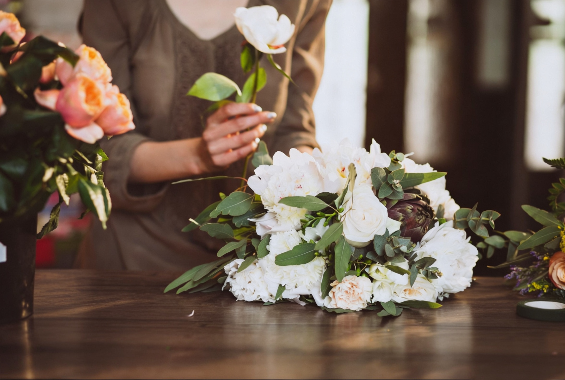 women holding rose and setting it on table in remembrance of someone